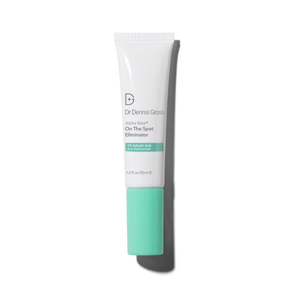 A tube of Dr. Dennis Gross Alpha Beta On The Spot Eliminator with a white body and green cap designed for spot treatment of acne.