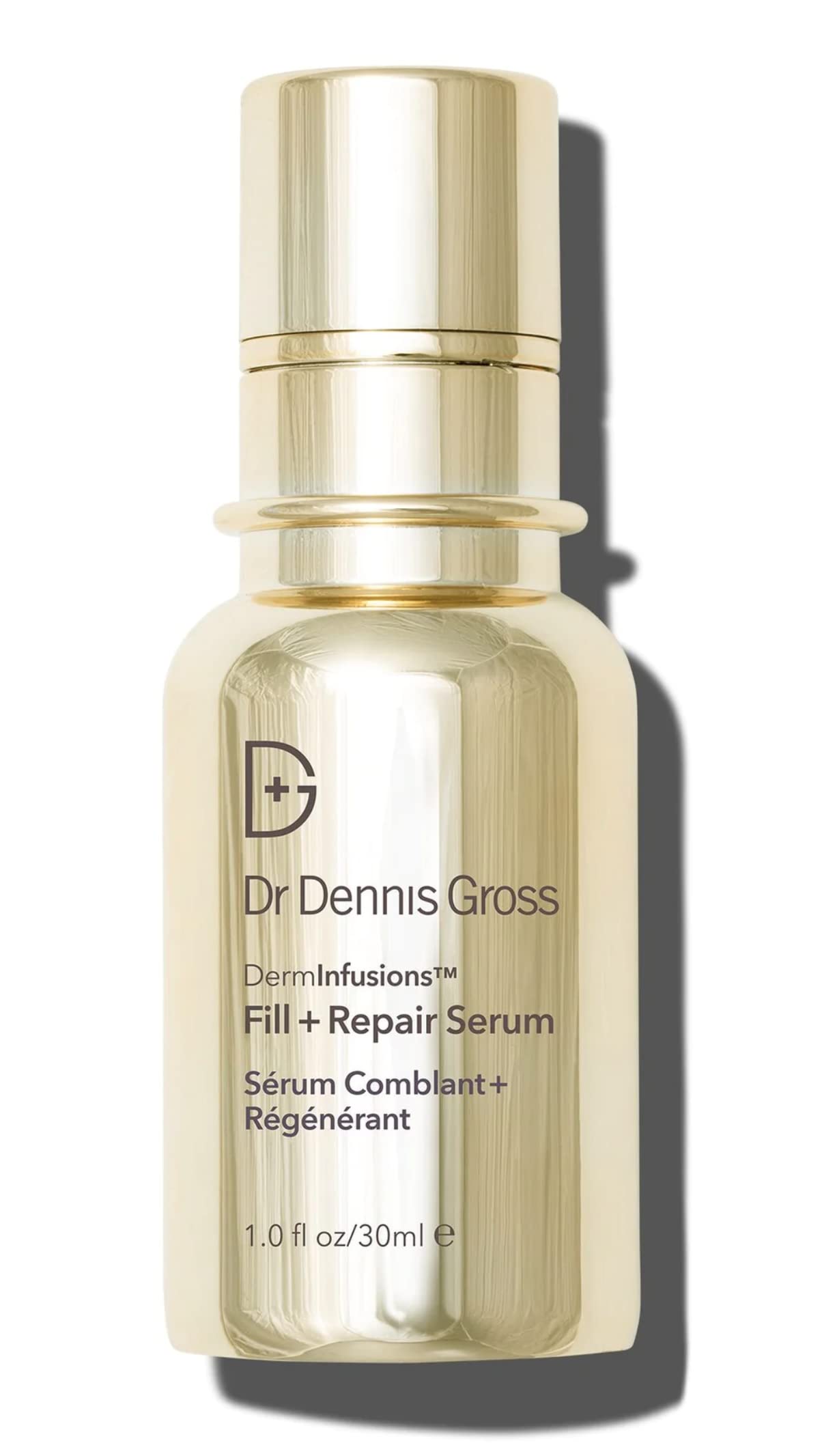 A bottle of Dr. Dennis Gross DermInfusions Fill + Repair Serum with a gold-colored label and a clear, amber liquid visible inside.